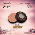 Artemis Aqua Base Makeup Shade 45 shown open on a pink background with floral accents.