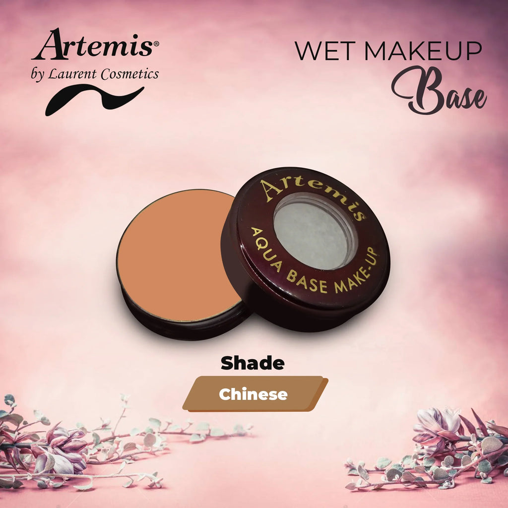 Artemis aqua base makeup in open compact, shade Chinese, on pink floral background.